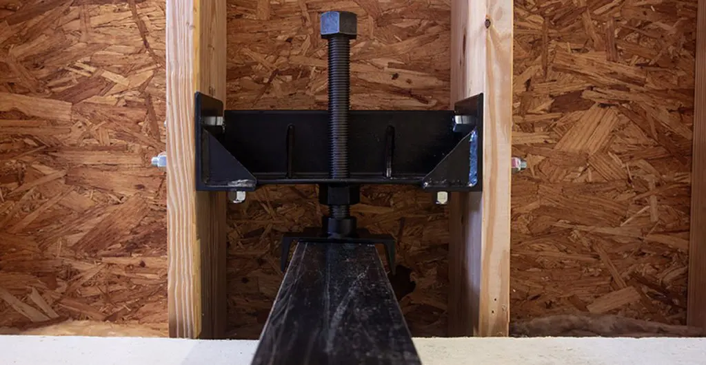 Intech Anchoring Systems Force Arrester Wall Brace System (WBS-9) black metal bracket installed on a wooden wall structure.