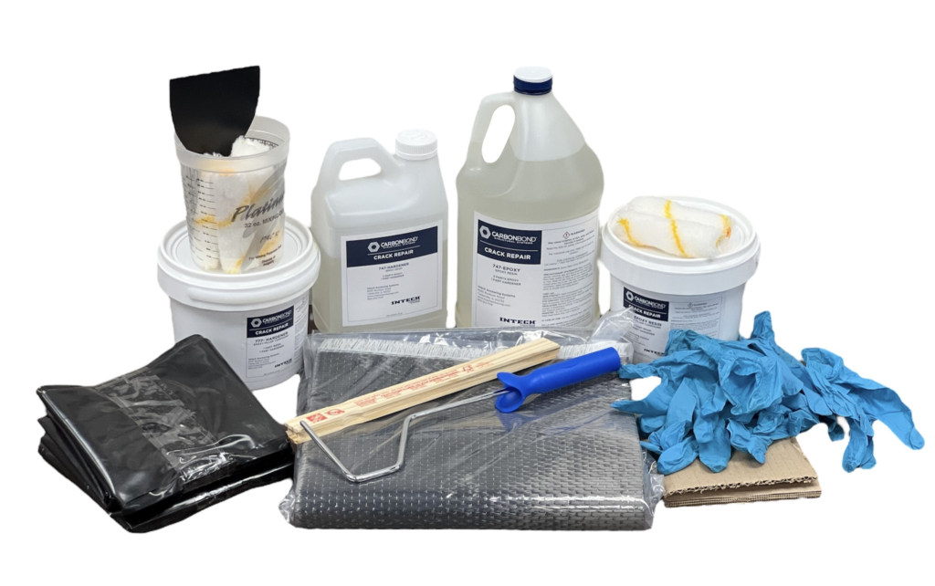 A collection of resin supplies including various containers of liquids, measuring cups, a stirring stick, a roller, a container with a lid, plastic sheet, blue disposable gloves, and black carbon fiber sheets. The items are arranged against a white background.